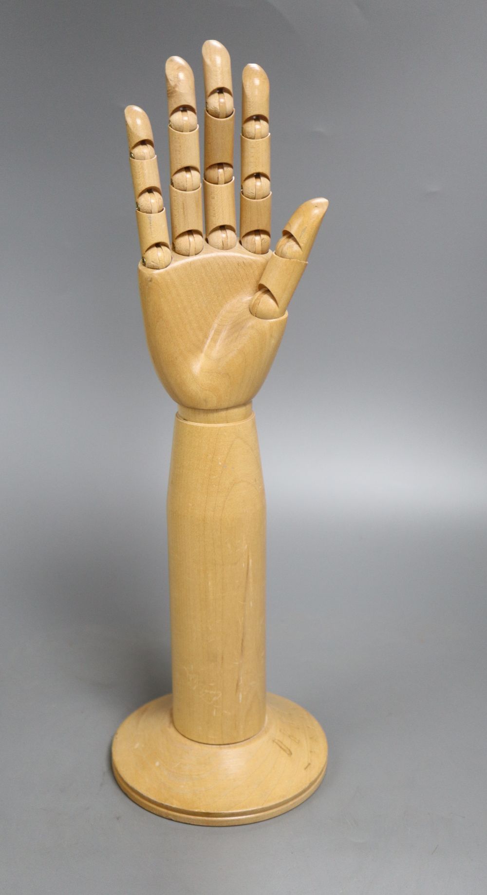 A mannequin hand, marked Dents 1777, overall height extended 40.5cm